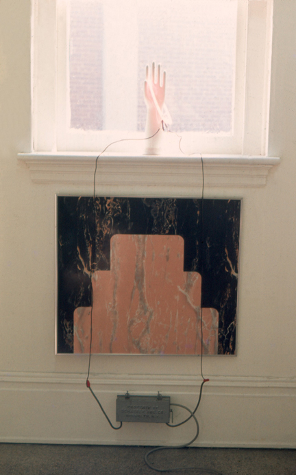 Titled Heart in Hand, this work employs neon, linoleum and a mannequins hand  