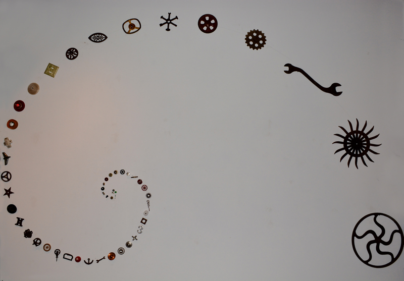 A wall installation by Harry Anderson taking the form of a spiral that is eight feet tall and thirteen feet wide